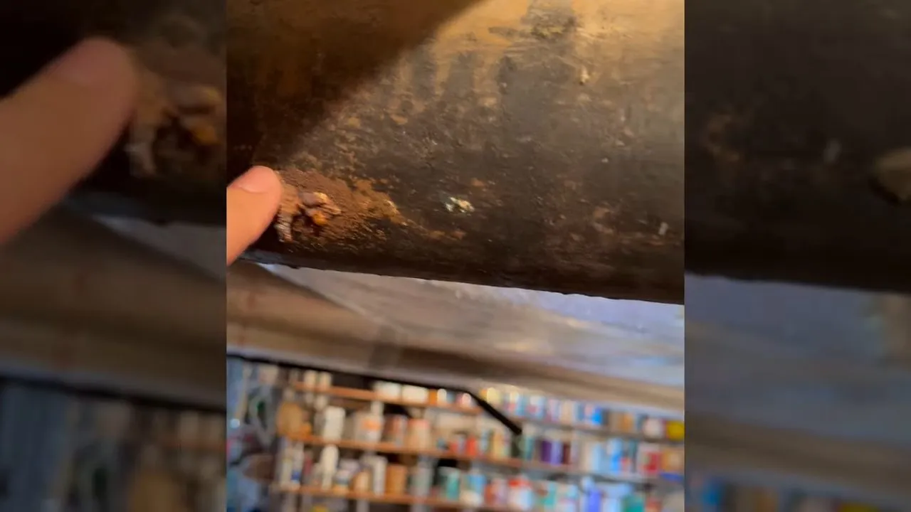Corroded cast-iron pipe inside a crawlspace