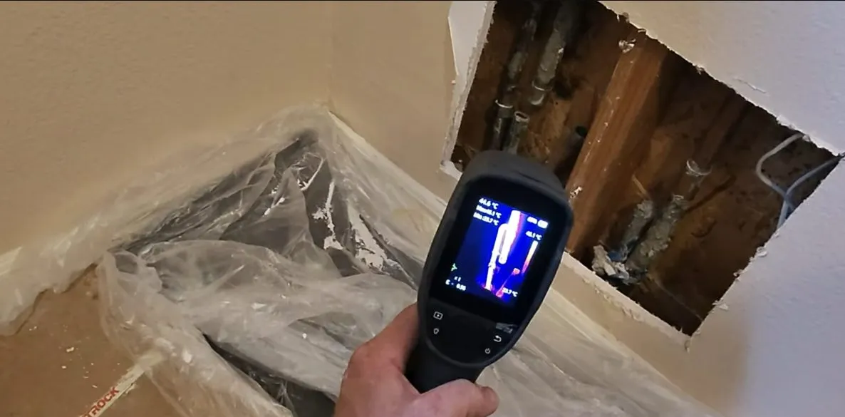 Digital leak detector screen held over a floor