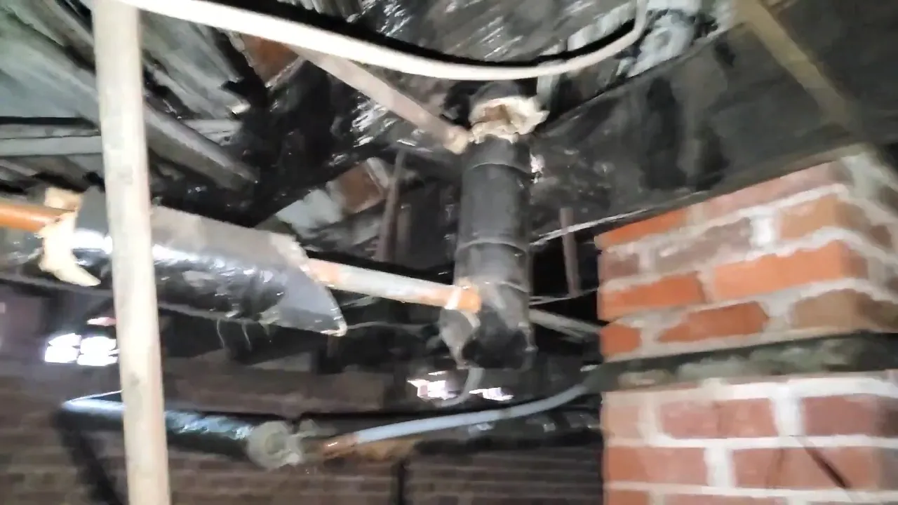 Rusty leaking joint in crawlspace plumbing