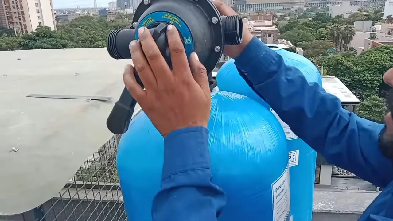 Technician carrying a blue water softener unit