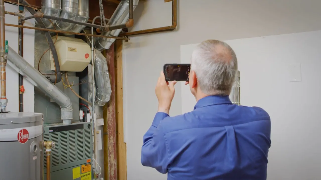 Technician inspecting an existing water heater