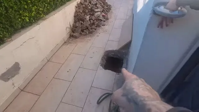 Tracing a water line beneath a cabinet