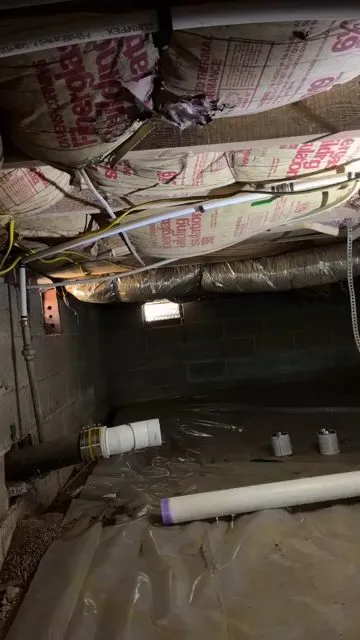 Wide crawlspace view before a drain upgrade